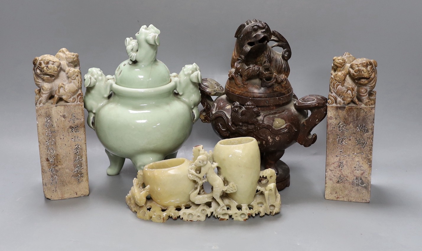 A Chinese celadon ground censer, together with a hardstone censer, a soapstone carving and two hardstone seals. Tallest 22cm